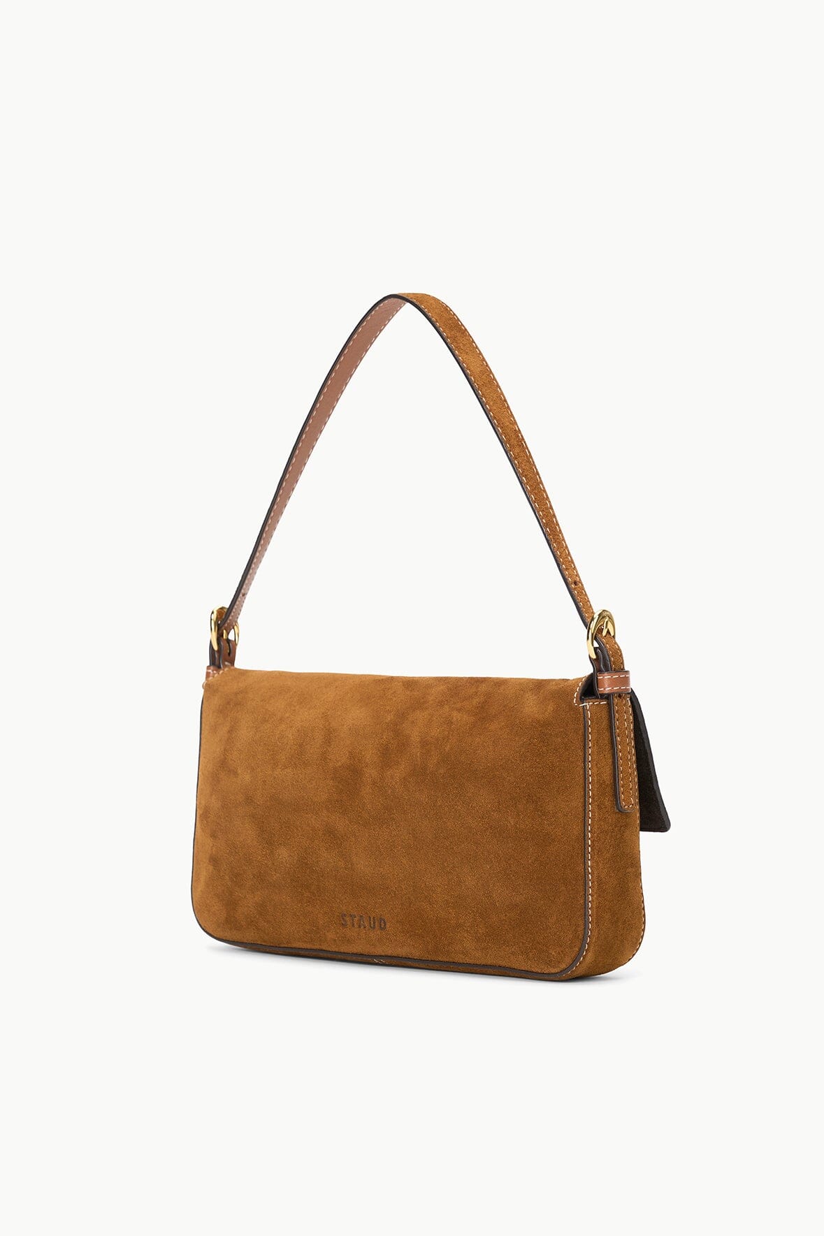 Tan suede Harlow bag side profile with front flap and metal hardware