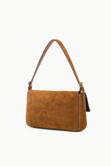 Tan suede Harlow bag side profile with front flap and metal hardware