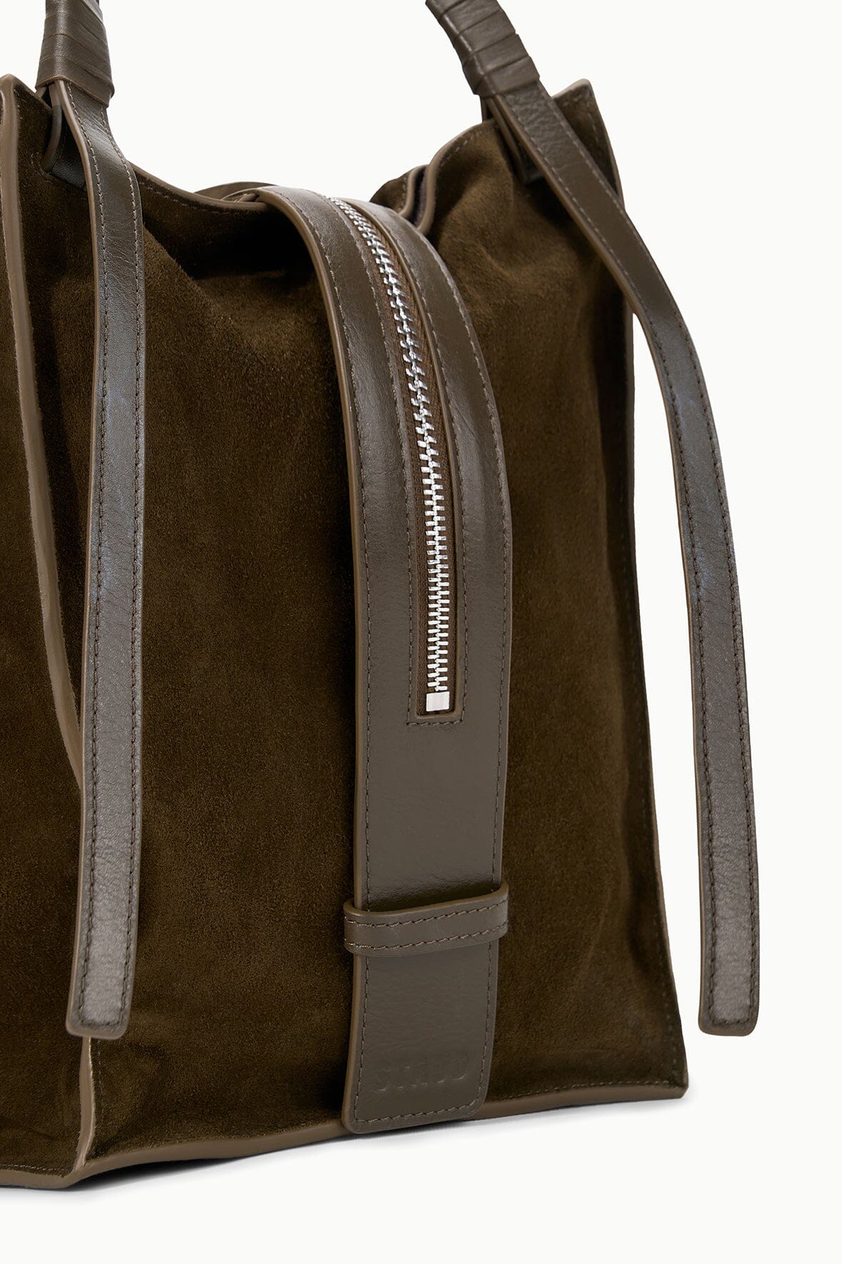 Truffle suede bag side view with zip pocket, contrast trim, and top handles