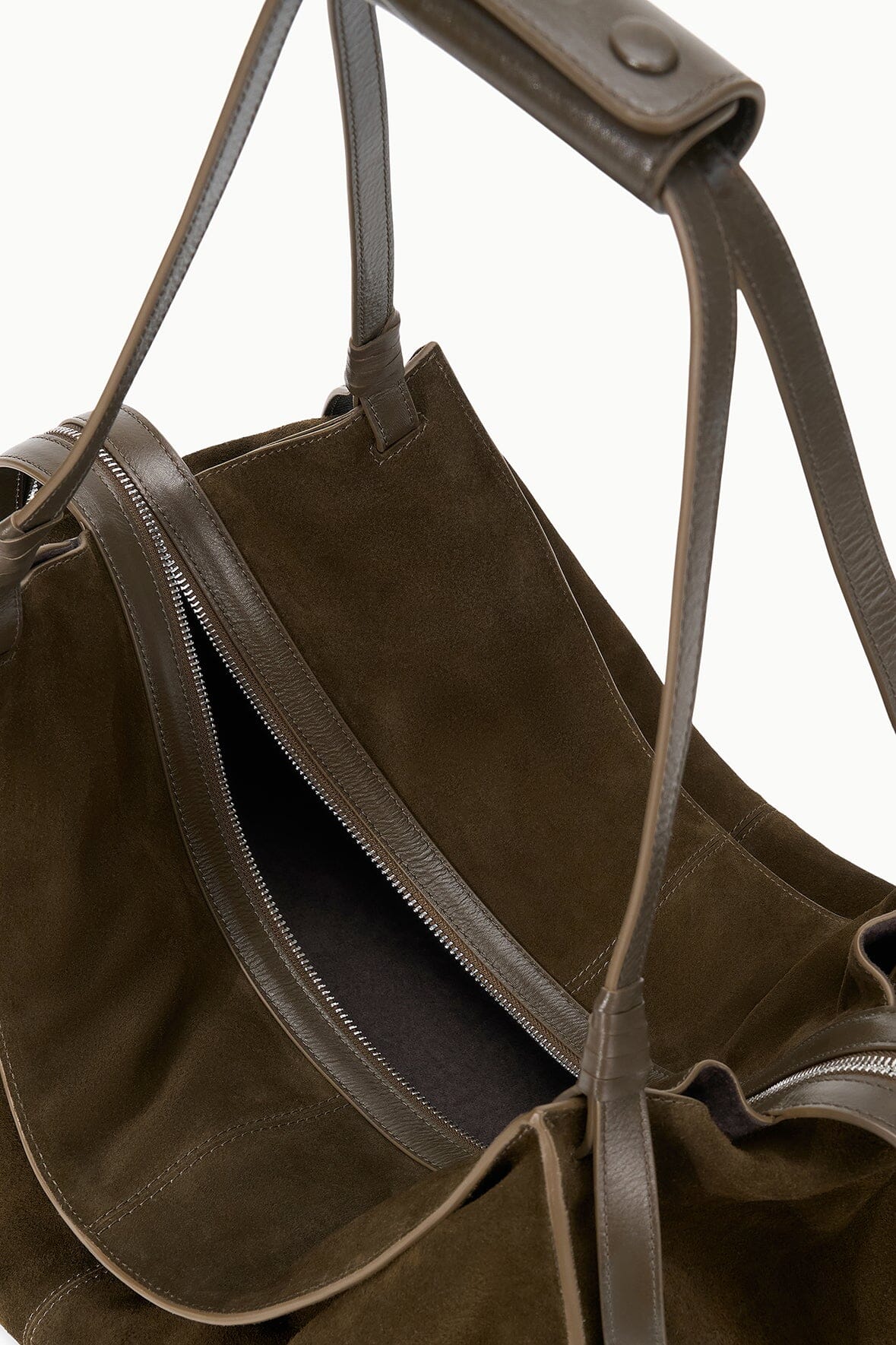Truffle suede tote bag with long handles, front zip pocket, and tassel details