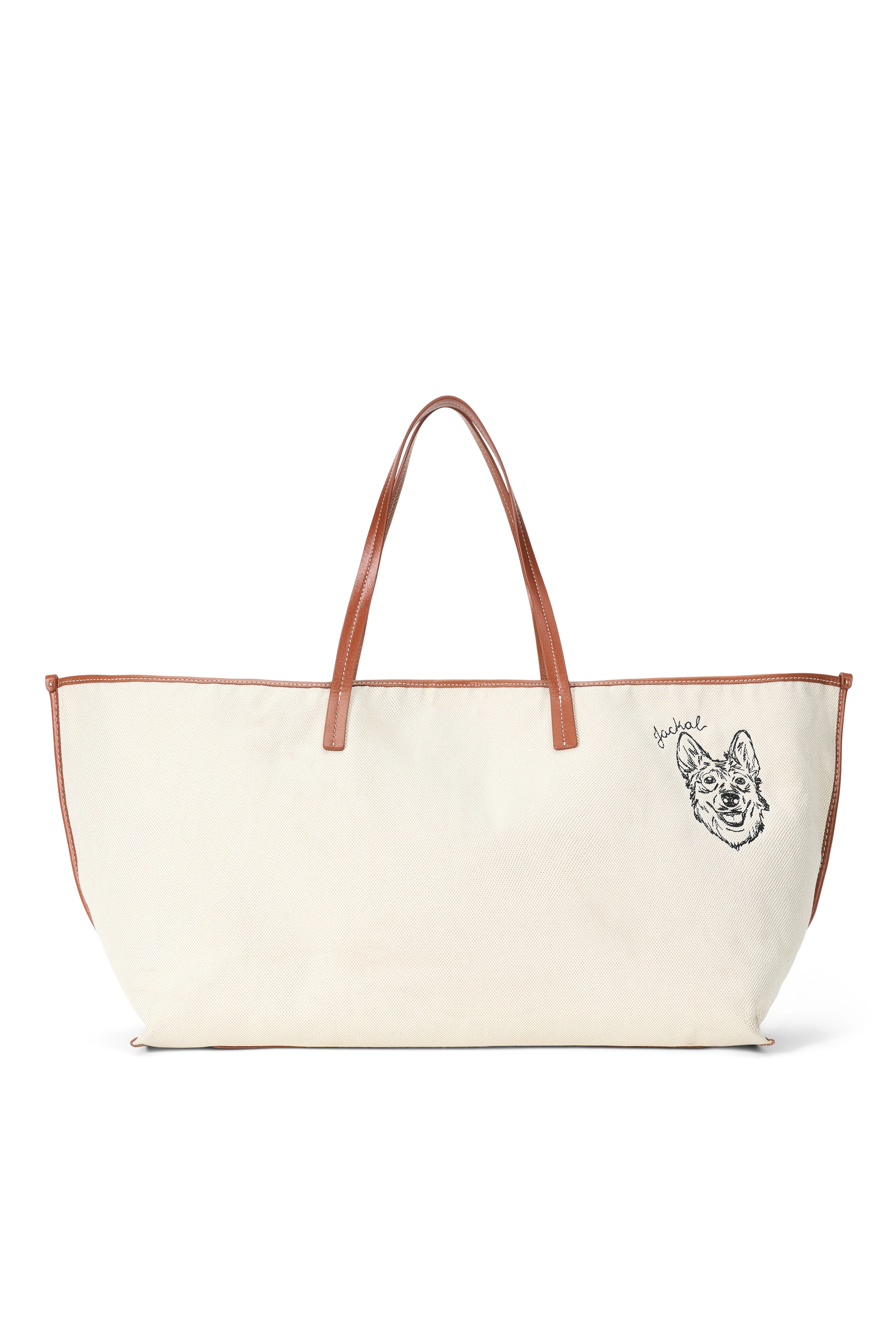Cream canvas tote bag with tan leather handles and black dog-face illustration
