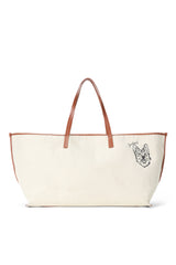 Cream canvas tote bag with tan leather handles and black dog-face illustration