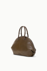 Truffle brown satchel angled view with two top handles and zip edge.