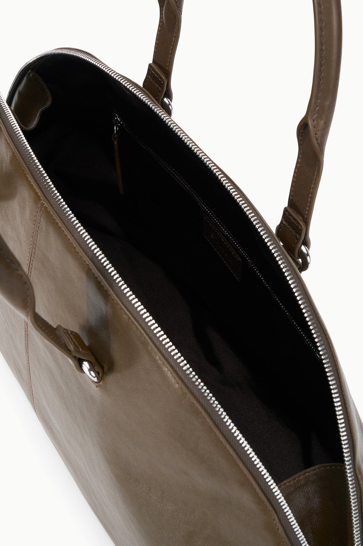 Truffle satchel open interior with zip top and stitched lining.