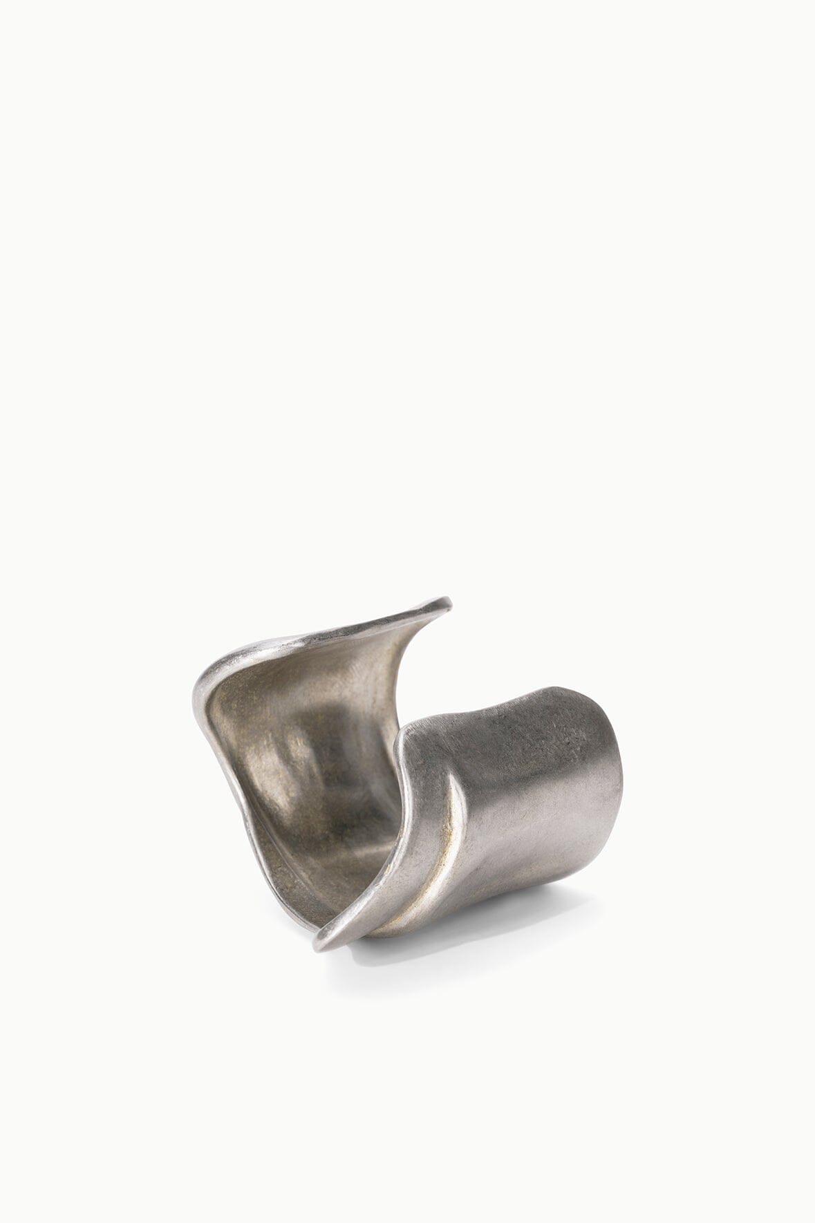 Silver-toned metal cuff bracelet, angled view showing sculpted folds