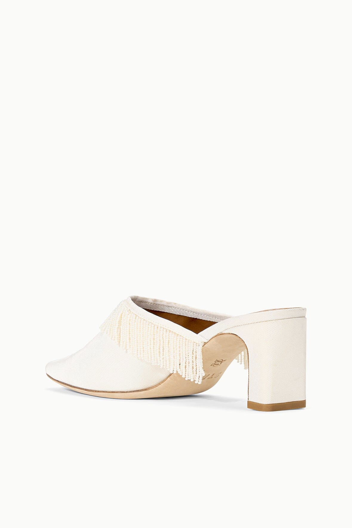 Ivory mule on block kitten heel with fringed trim and curved toe