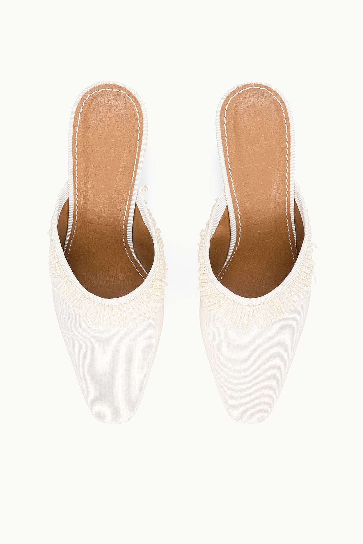 Ivory mules front view with pointed toe and fringed open back