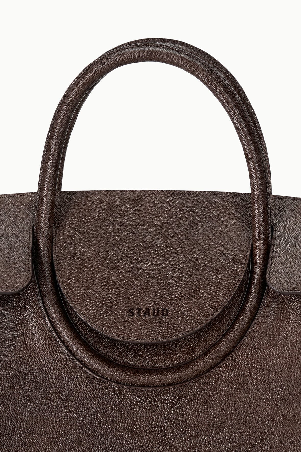 Large Maude carryall bag with embossed logo on rounded center flap and top handles