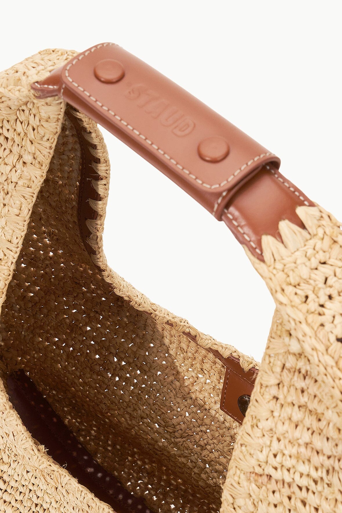 Raffia moon tote bag interior with brown leather-look trim and stitched edge