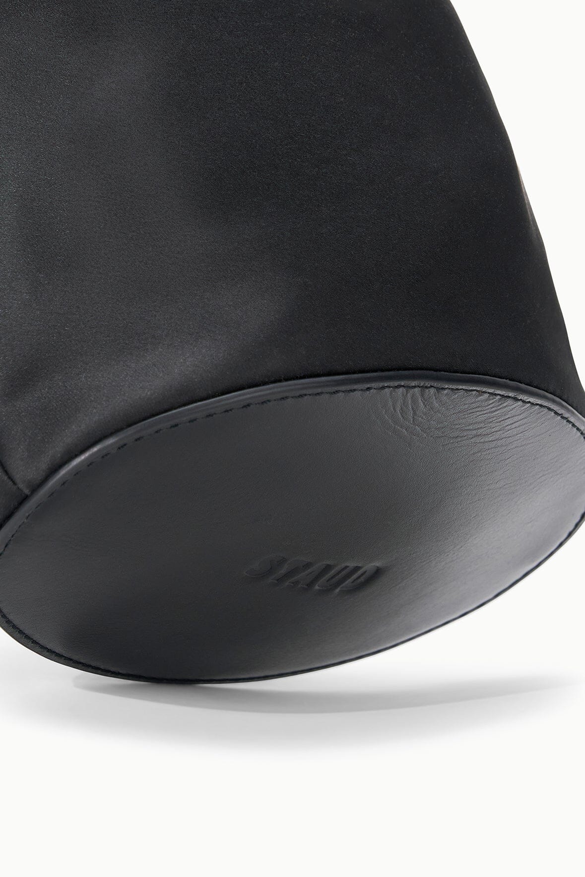 Black mini bucket bag bottom and side seam with smooth leather-look panel trim