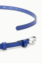 Cobalt slim buckle belt with moon-shaped metal buckle and textured leather strap
