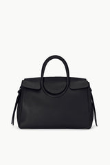 Maude carryall bag in black with curved top handle and side tassel accents.