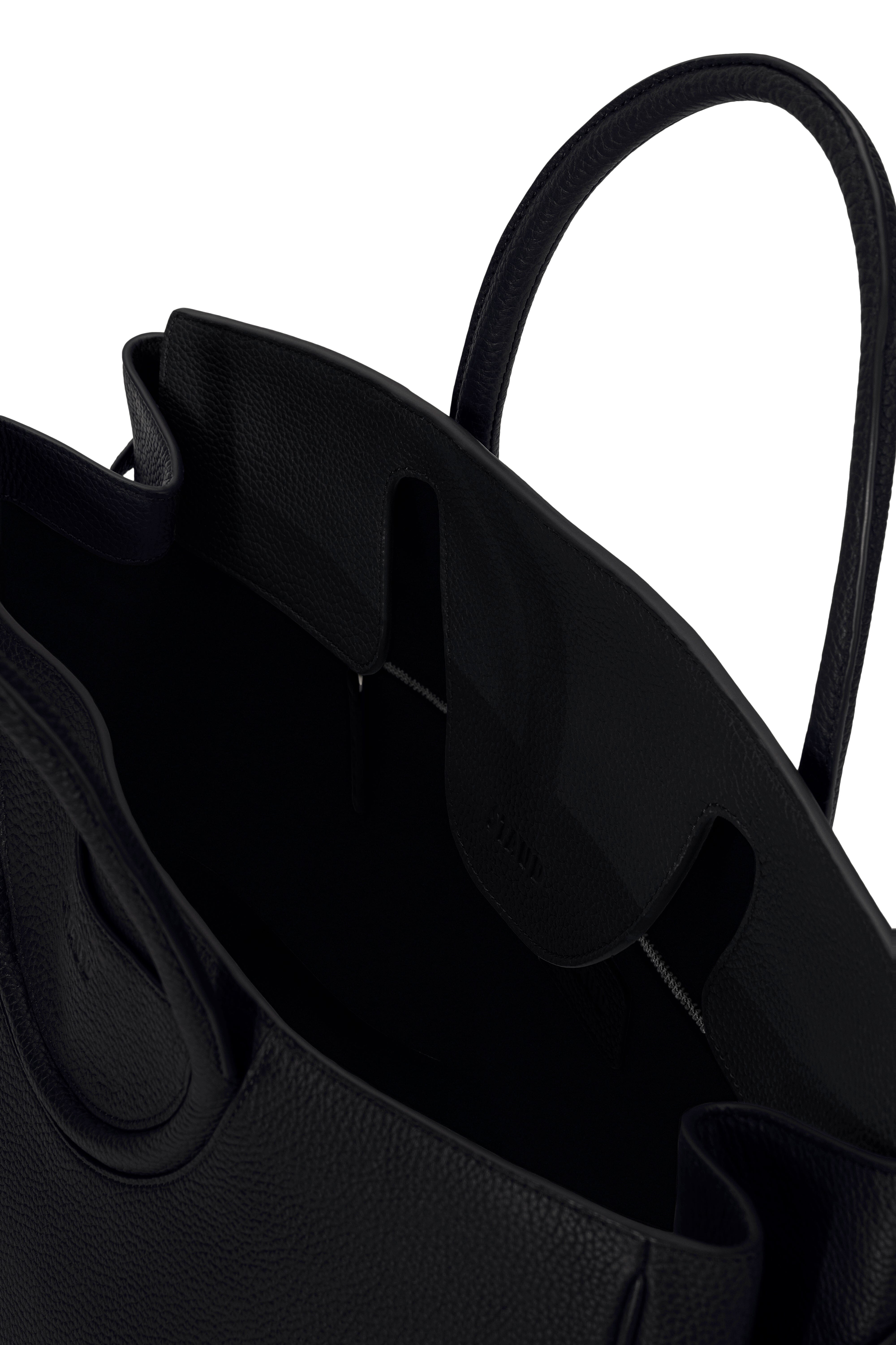 Maude carryall bag interior showing black lining and front pocket flap.