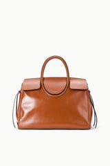 Tabac leather carryall bag with oval handle, front pocket panels, and dangling straps
