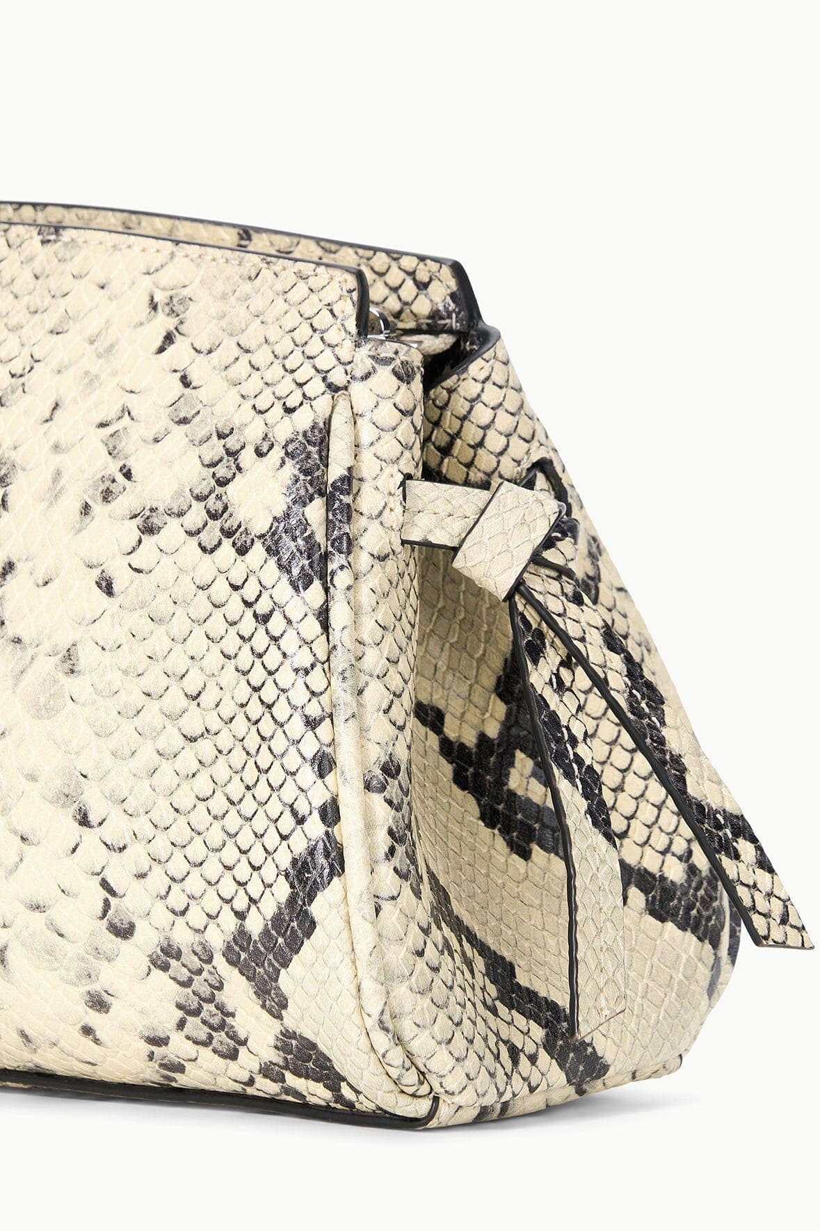 Convertible clutch bag, white snake-print, side view with fold-over strap detail