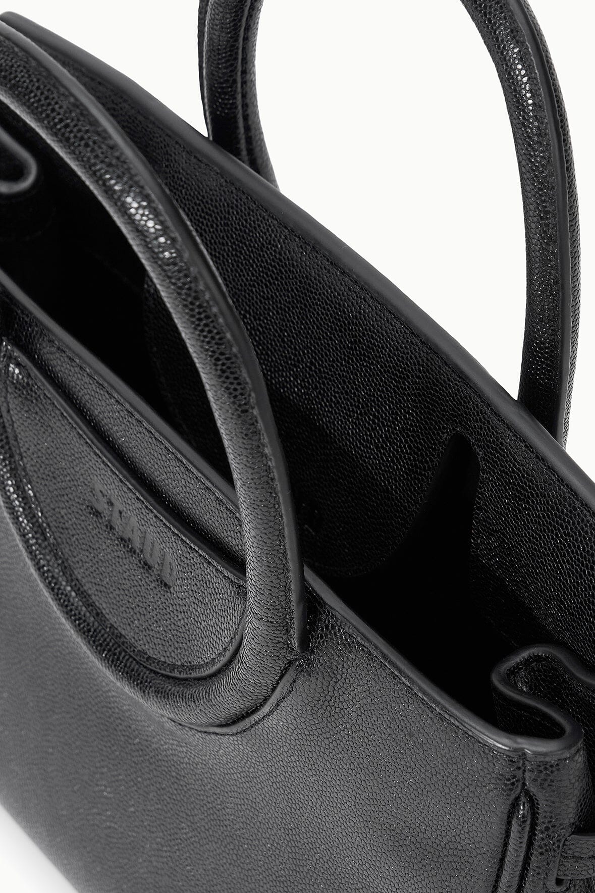 Black Maude mini carryall bag with textured finish, side panel and handle loop