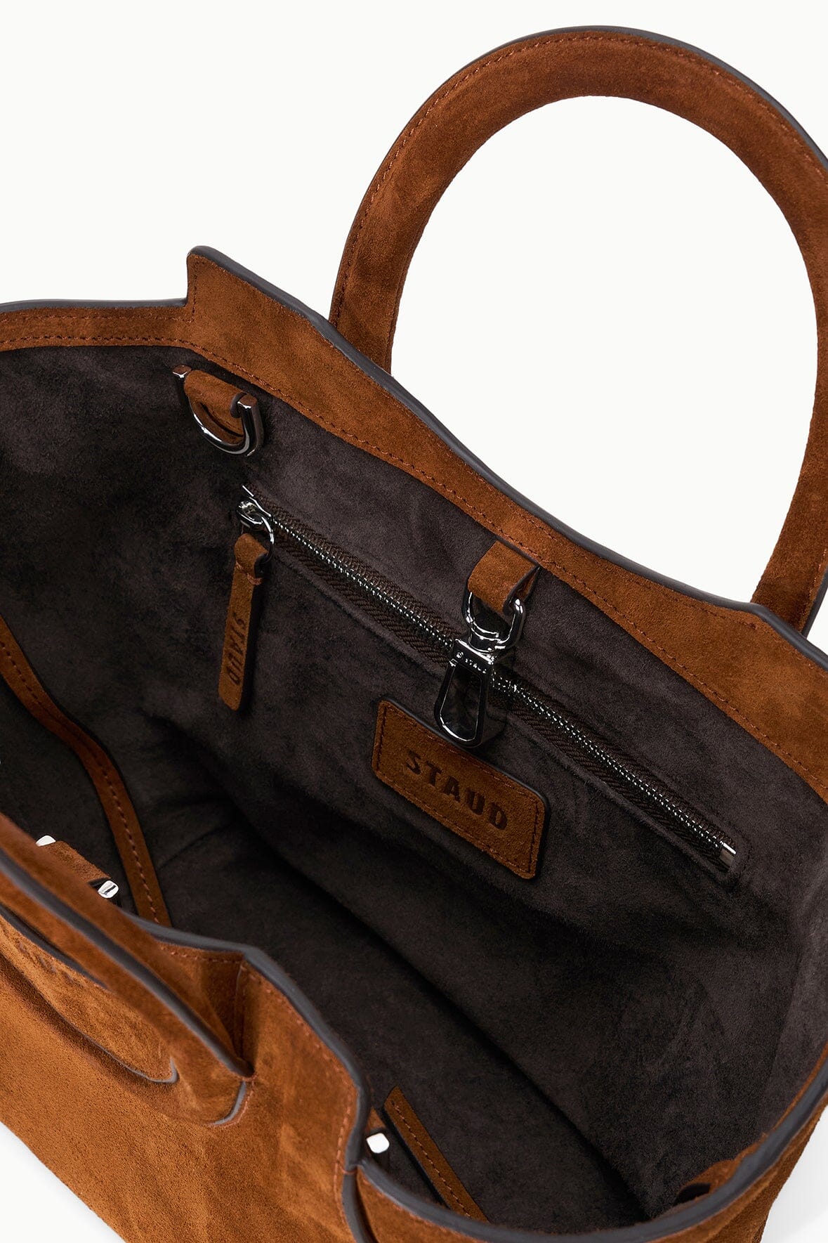 Tabac suede mini tote interior with zip pocket and leather logo plaque