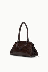 Brown croc-embossed shoulder bag with short handles and side folds