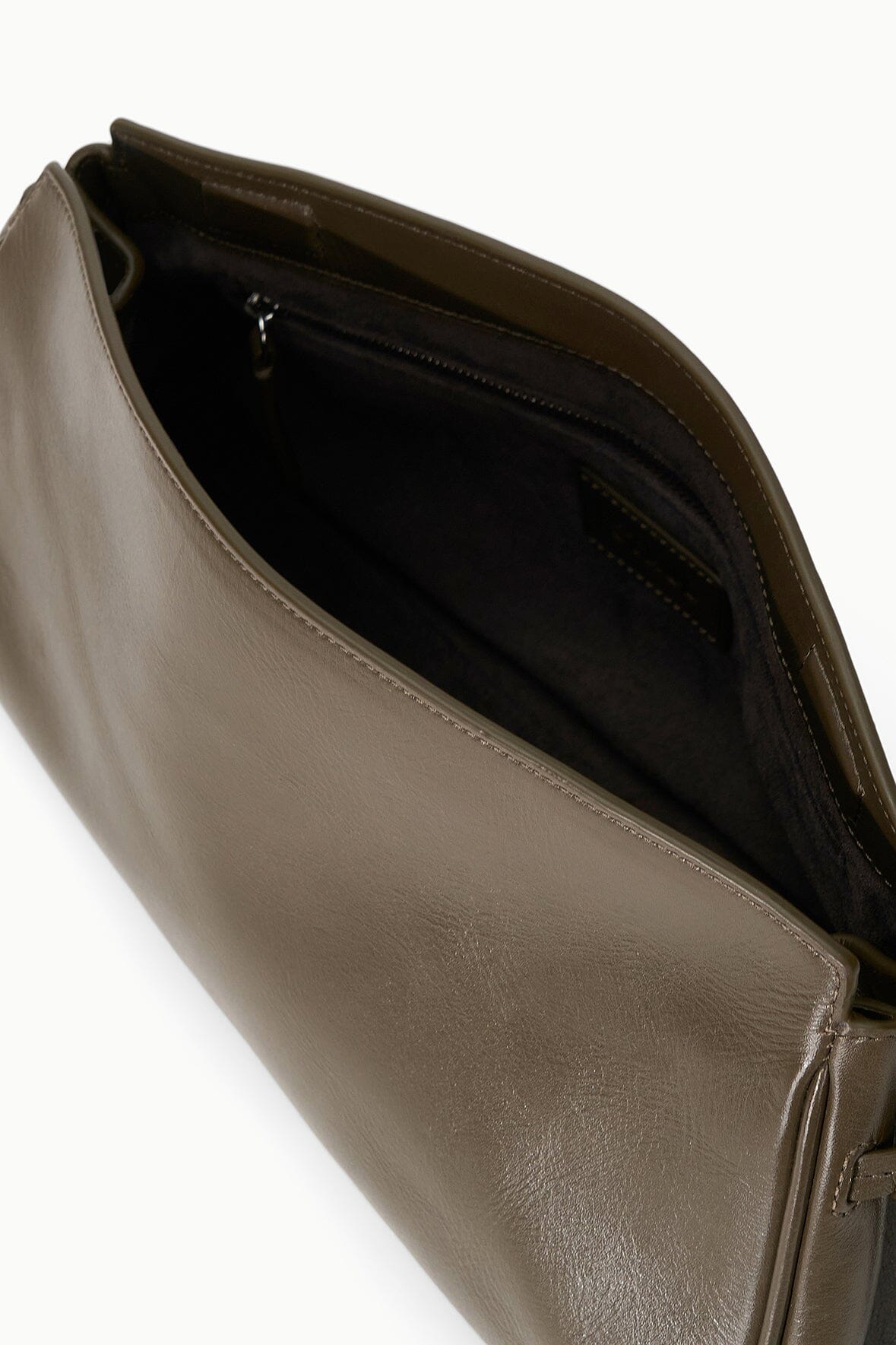 Truffle-brown leather clutch interior with dark lining and zipper pocket
