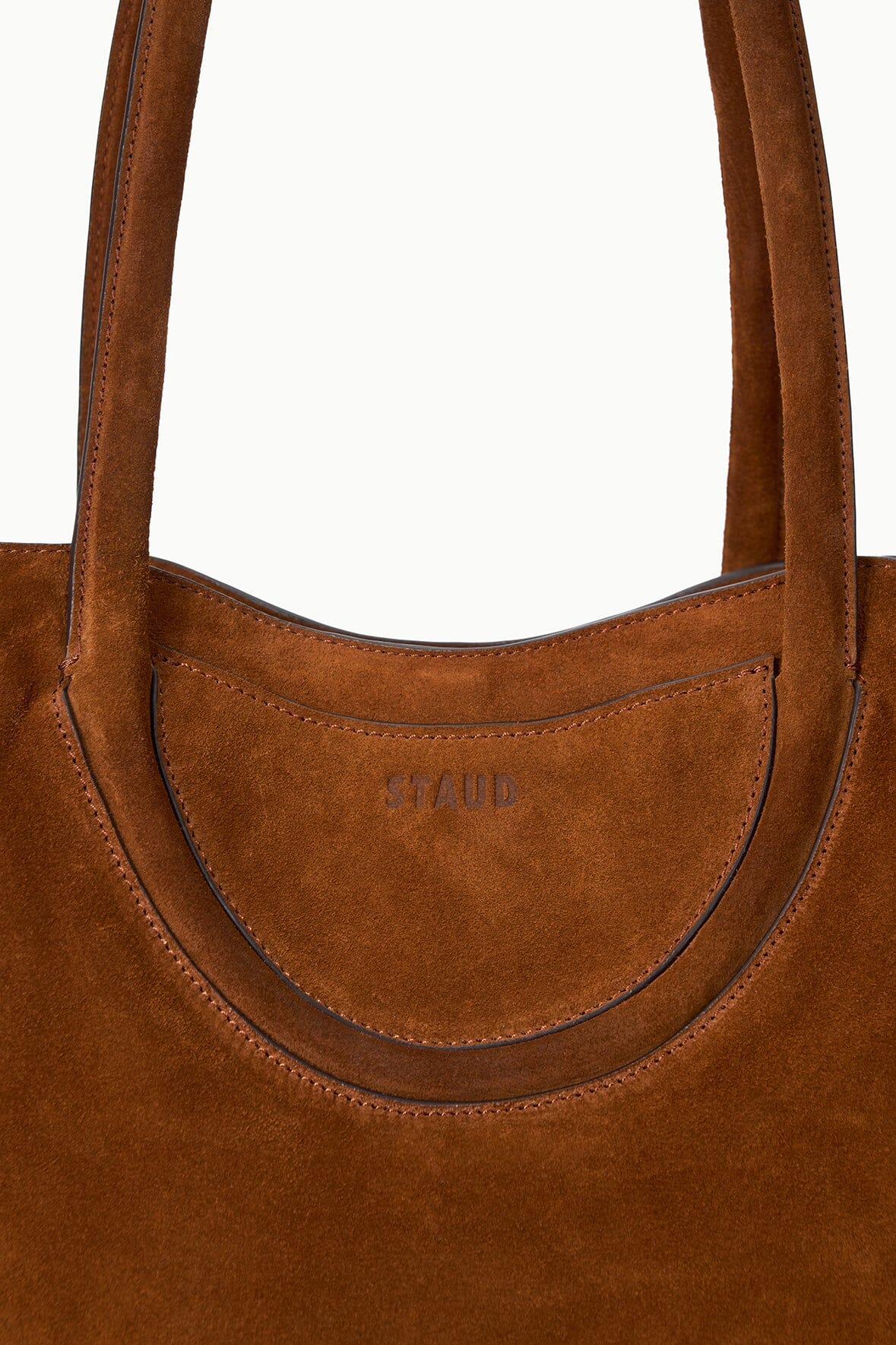 Tabac suede tote bag close-up of curved front pocket and stitched trim
