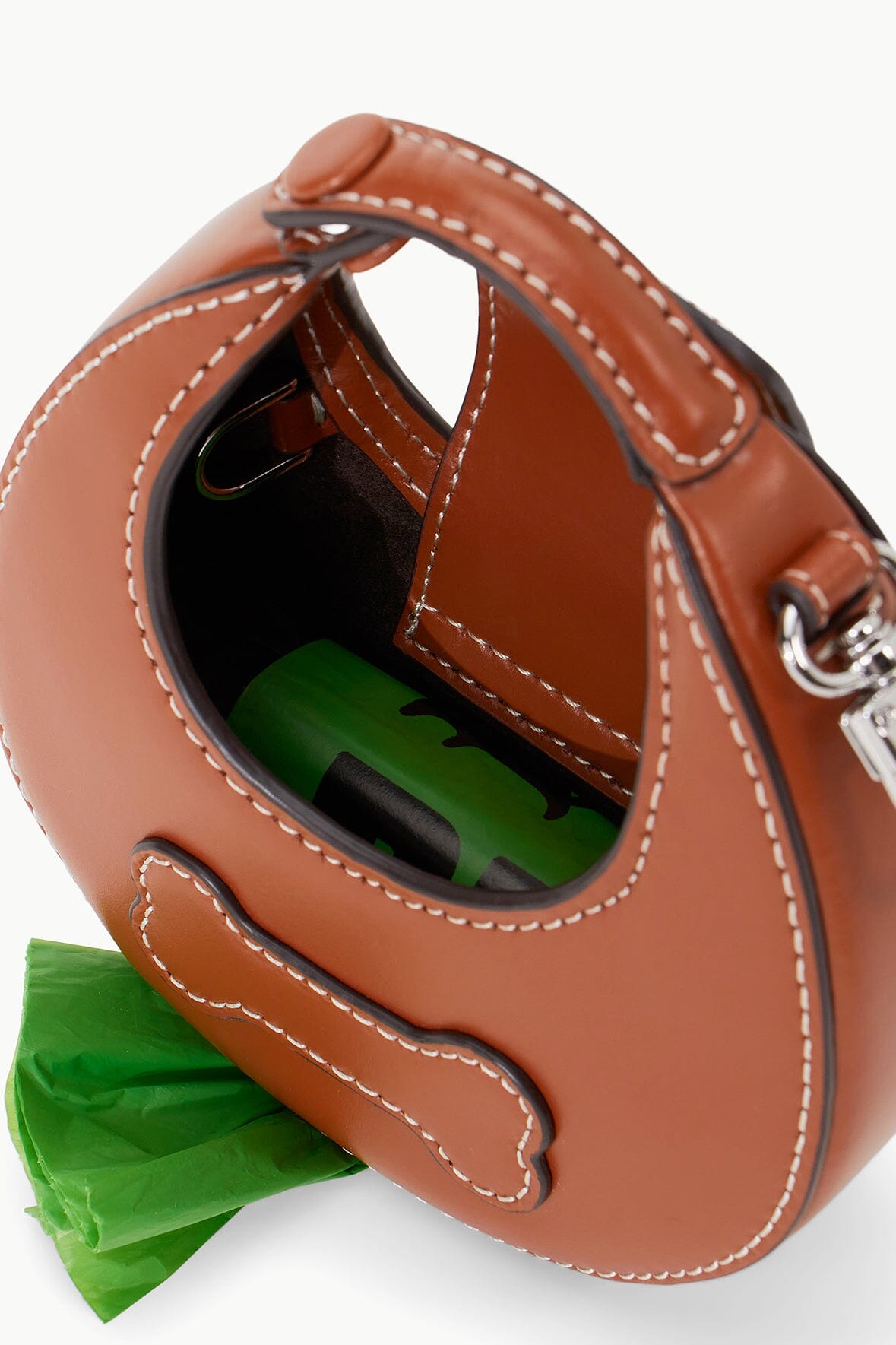 Tan poop bag carrier showing interior slot with green bag and stitched trim