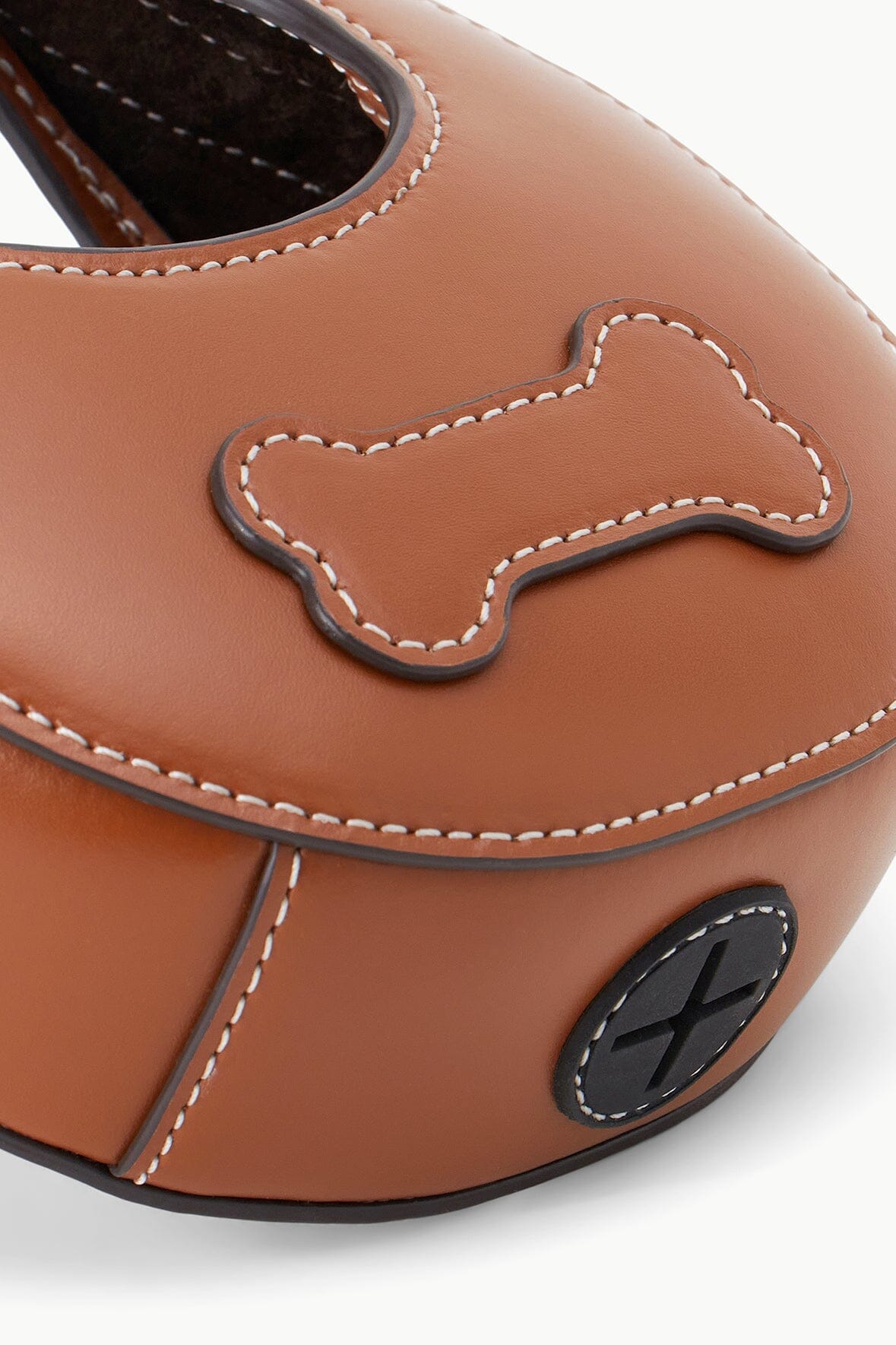 Tan micro moon poop bag carrier close-up of bone applique and black oval detail