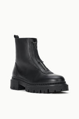 Black ankle boot with side zipper, pull tab, and thick lug sole.