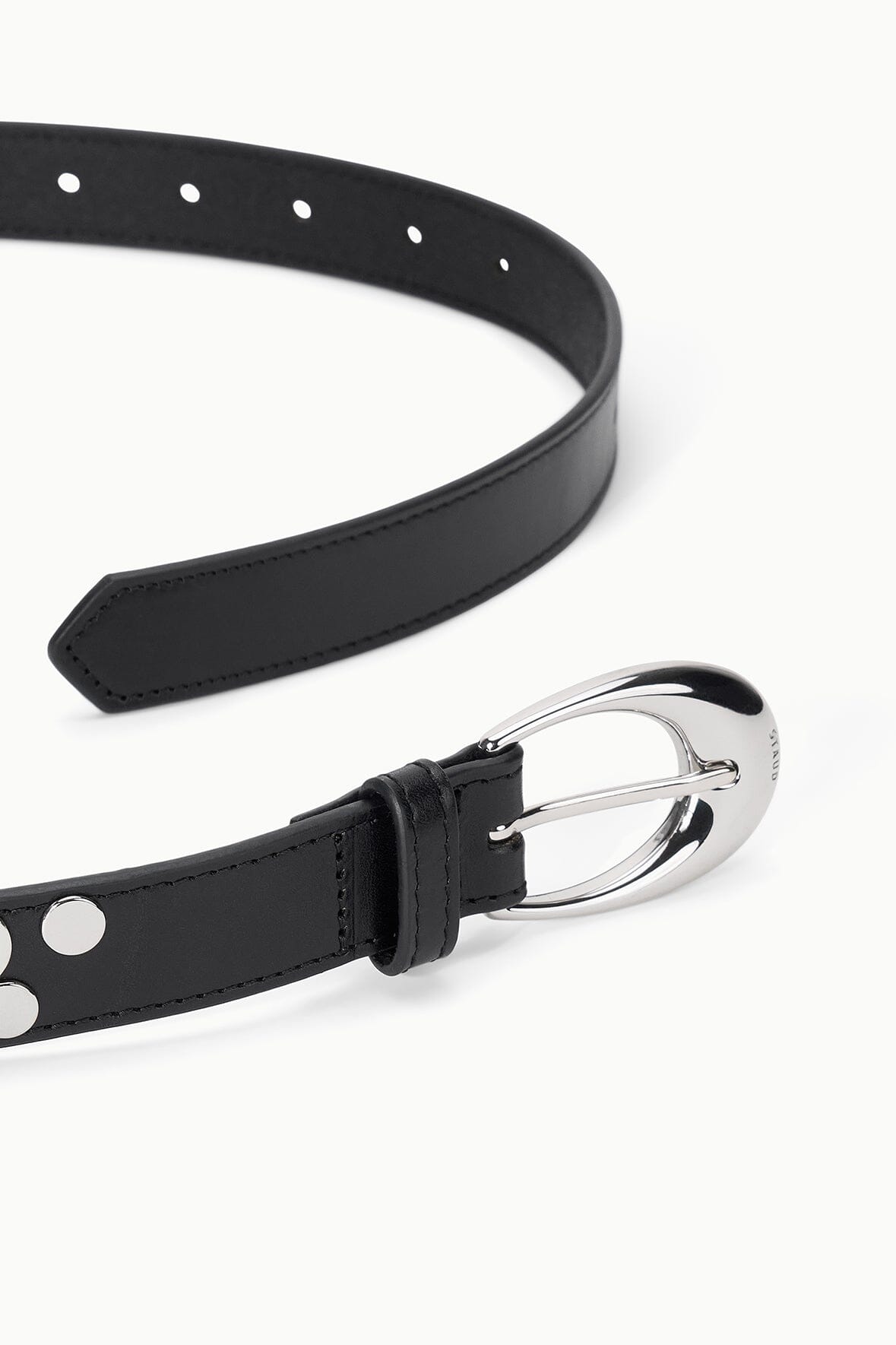 Black leather-look belt close-up with silver moon buckle and studded trim