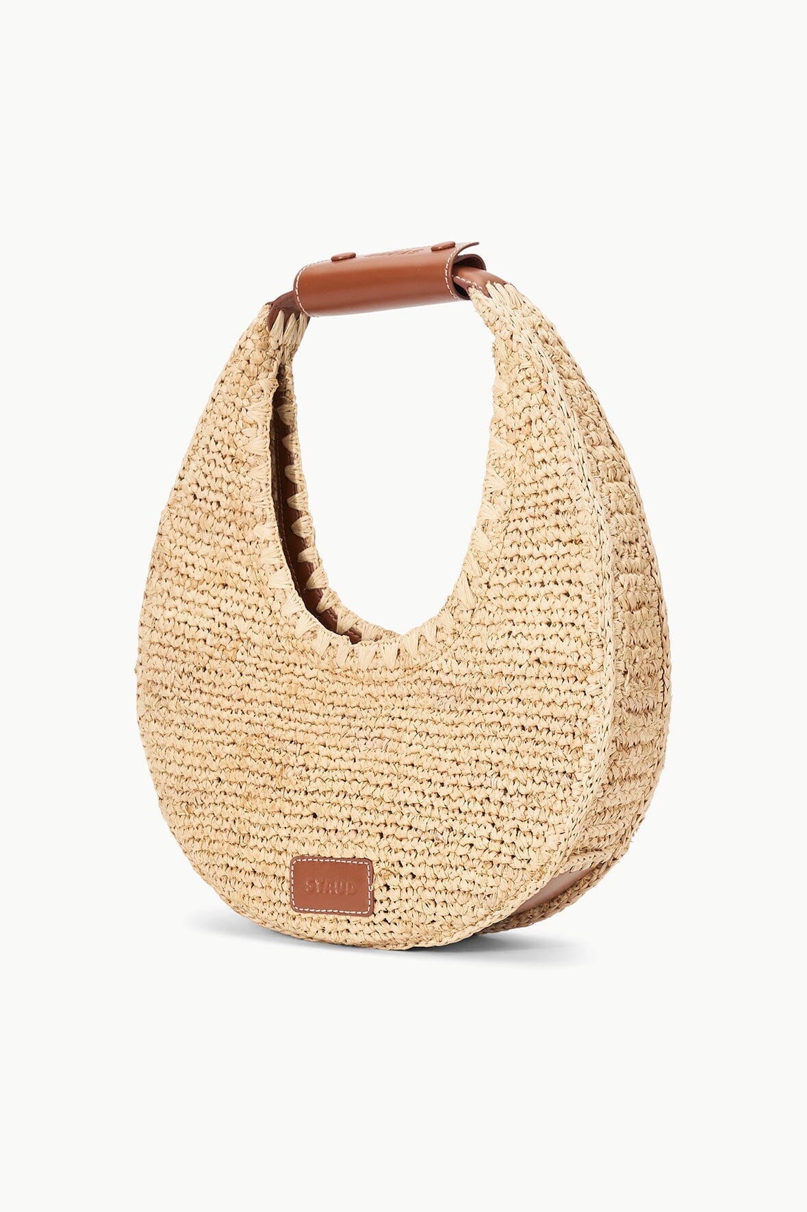 Natural raffia crescent bag with brown leather patch and short top handle
