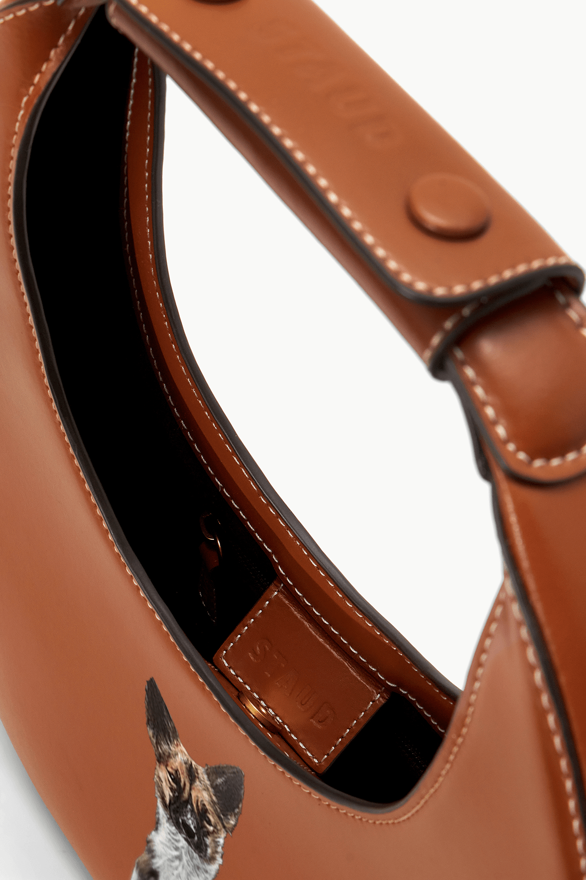Tan moon bag interior view with curved opening and contrast-stitched seam