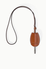 Tan-brown leather whistle pouch on cord with metal whistle tip