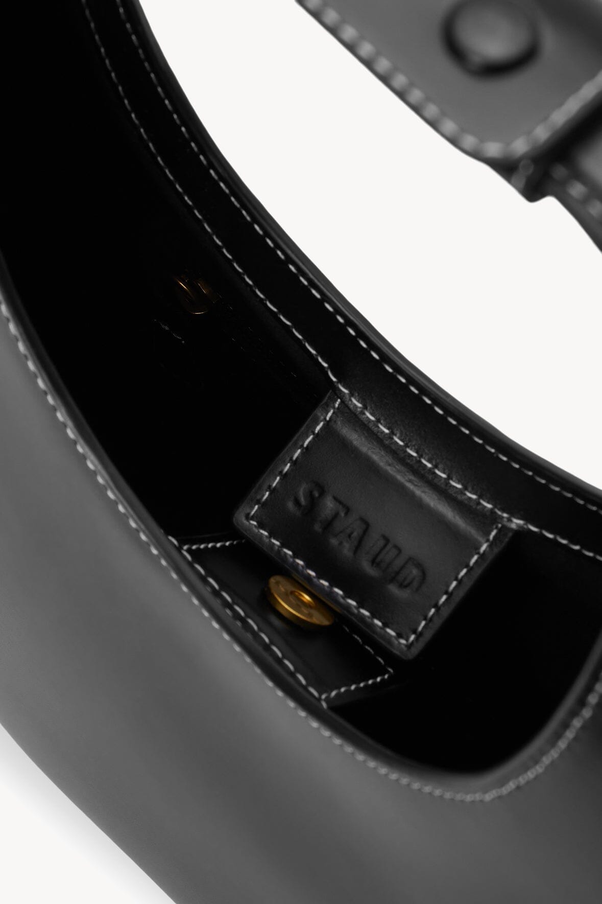Black bag interior pocket with stitched label panel
