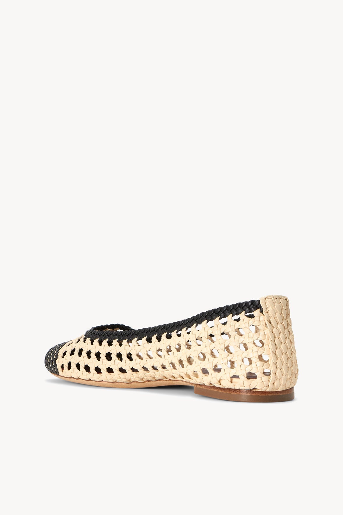 Cream and black crochet ballerina flats with low tan sole, back angle