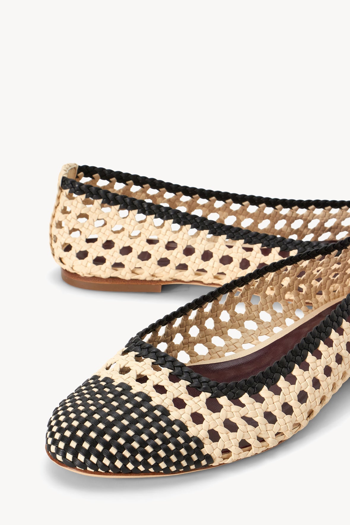 Cream and black crochet ballerina flats, close-up of braided straps and pattern
