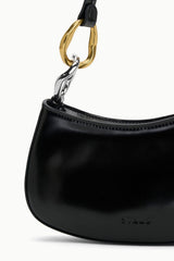 Black hobo bag with gold ring clasp and embossed logo