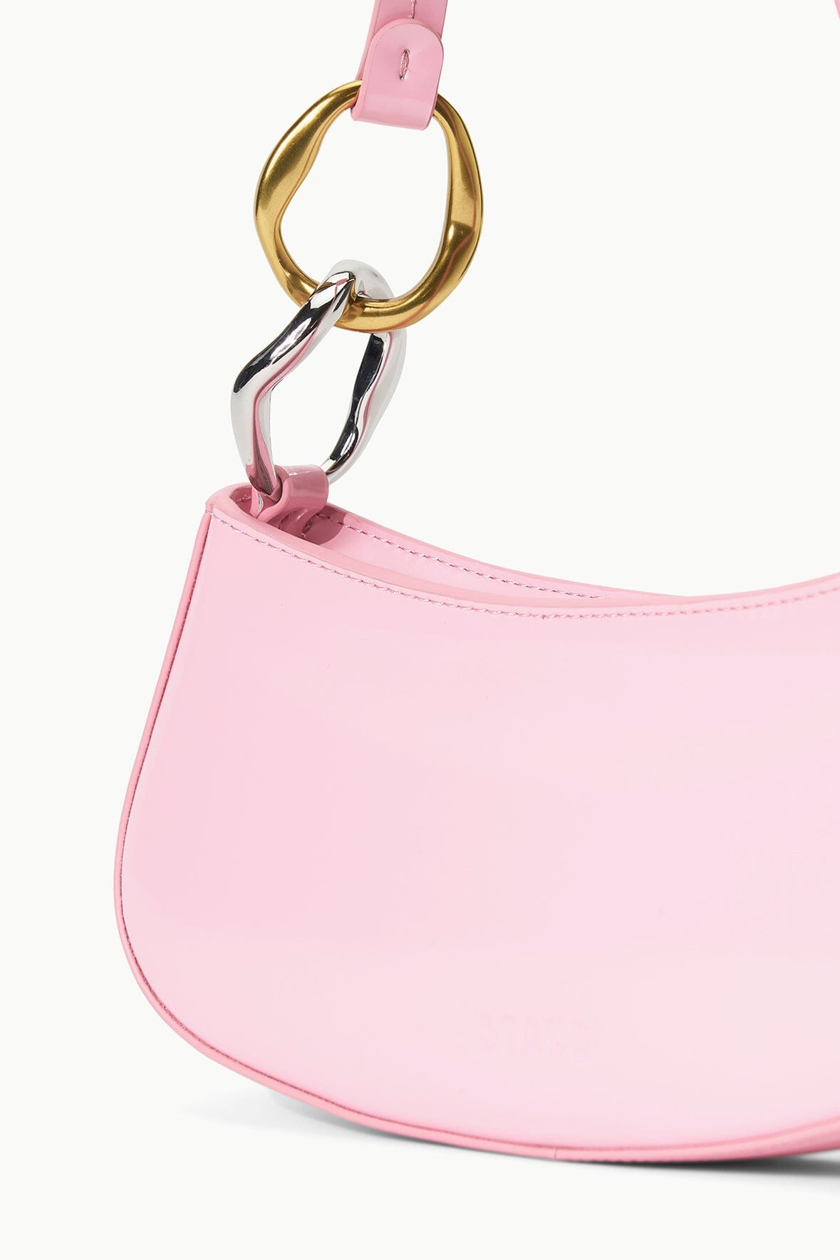 Pink hobo bag detail with gold ring clasp and stitched strap end