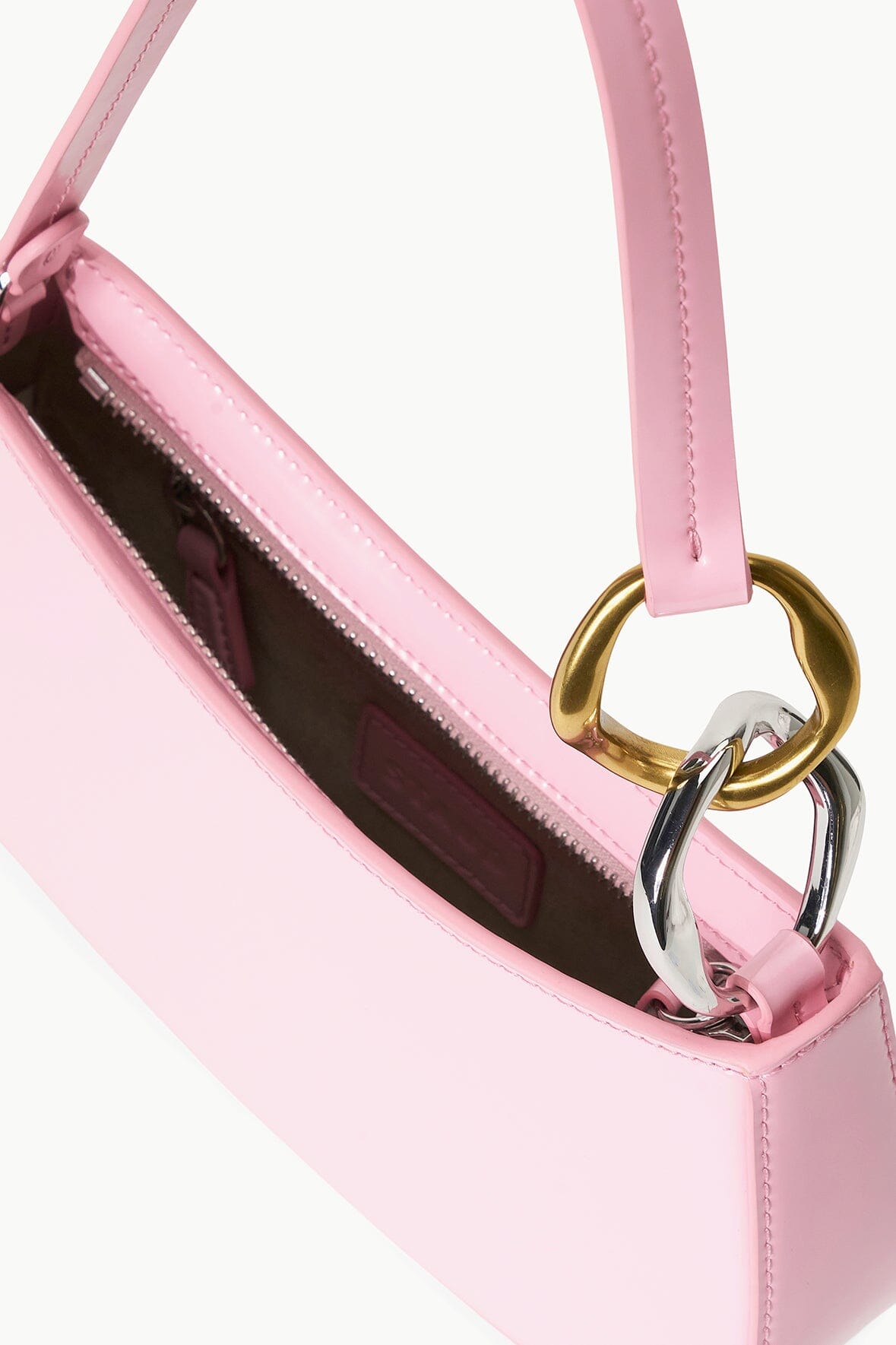 Pink hobo bag interior view with dark lining and gold-tone ring hardware