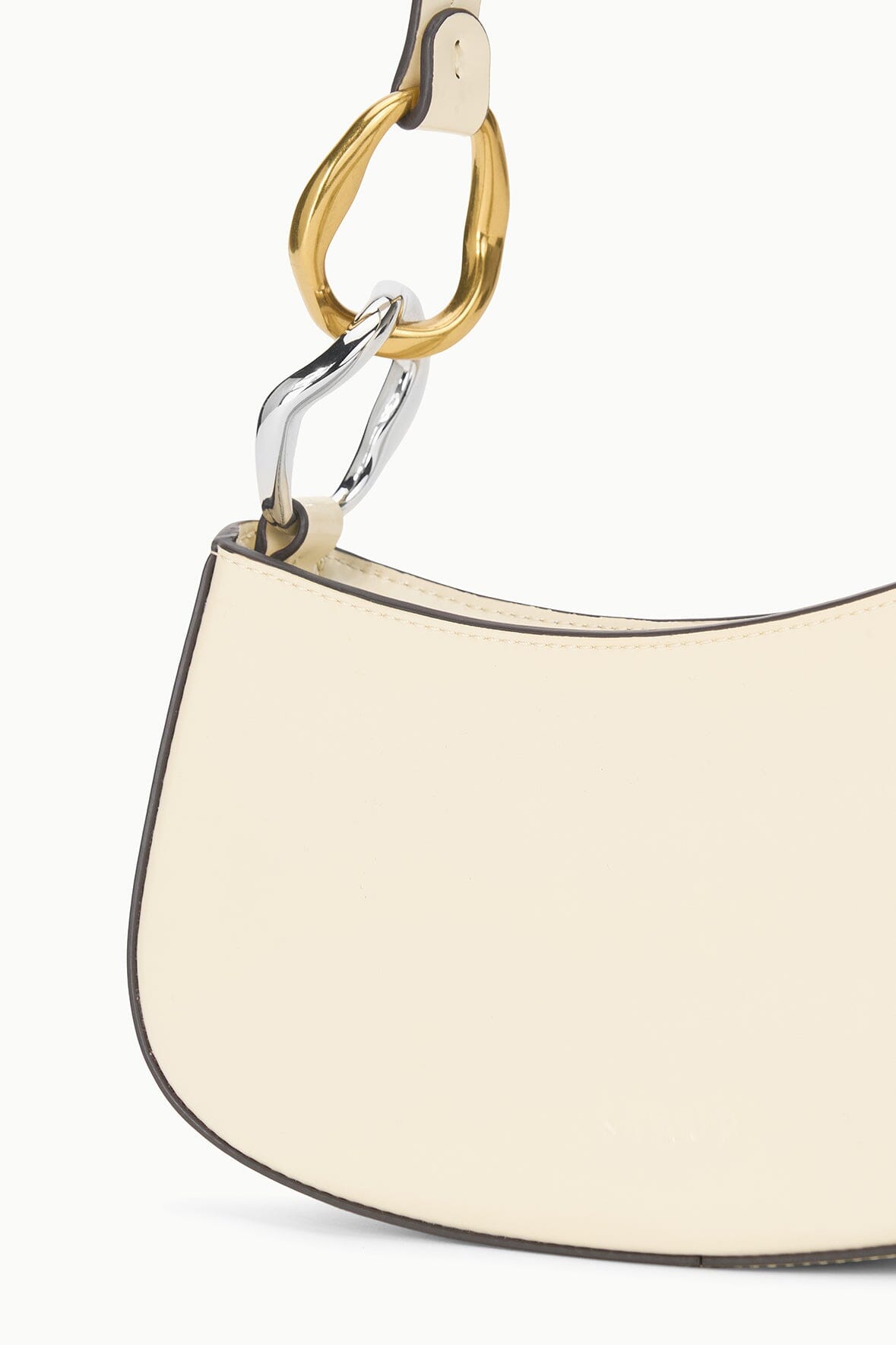 Close-up of cream hobo bag top hardware loop and metal rings