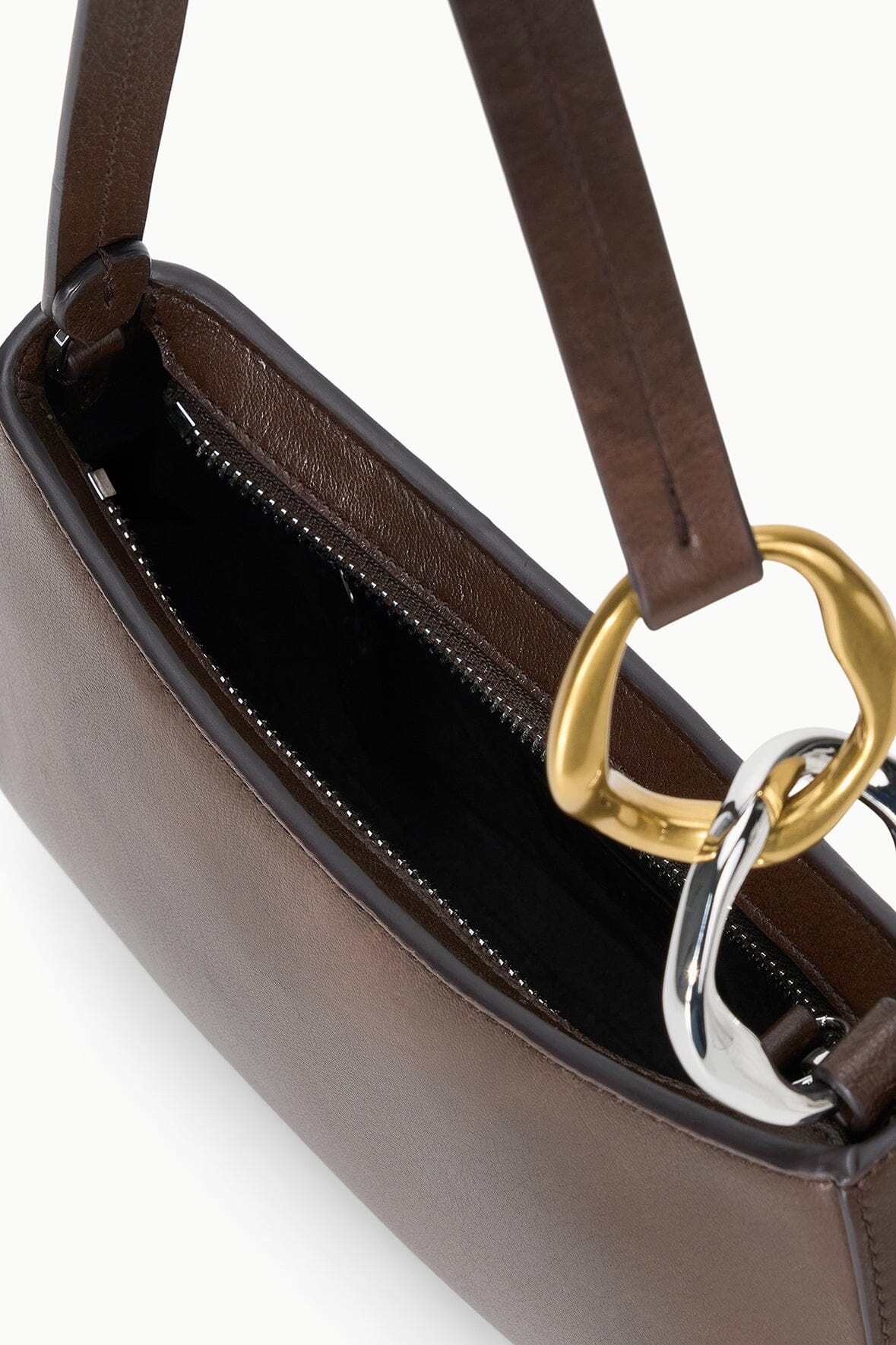 Ollie bag interior view with zip top, black lining, and gold-and-brown hardware