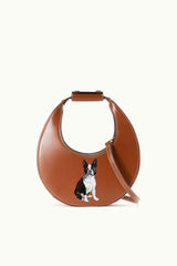 Tan mini moon bag with dog print panel and adjustable shoulder strap.