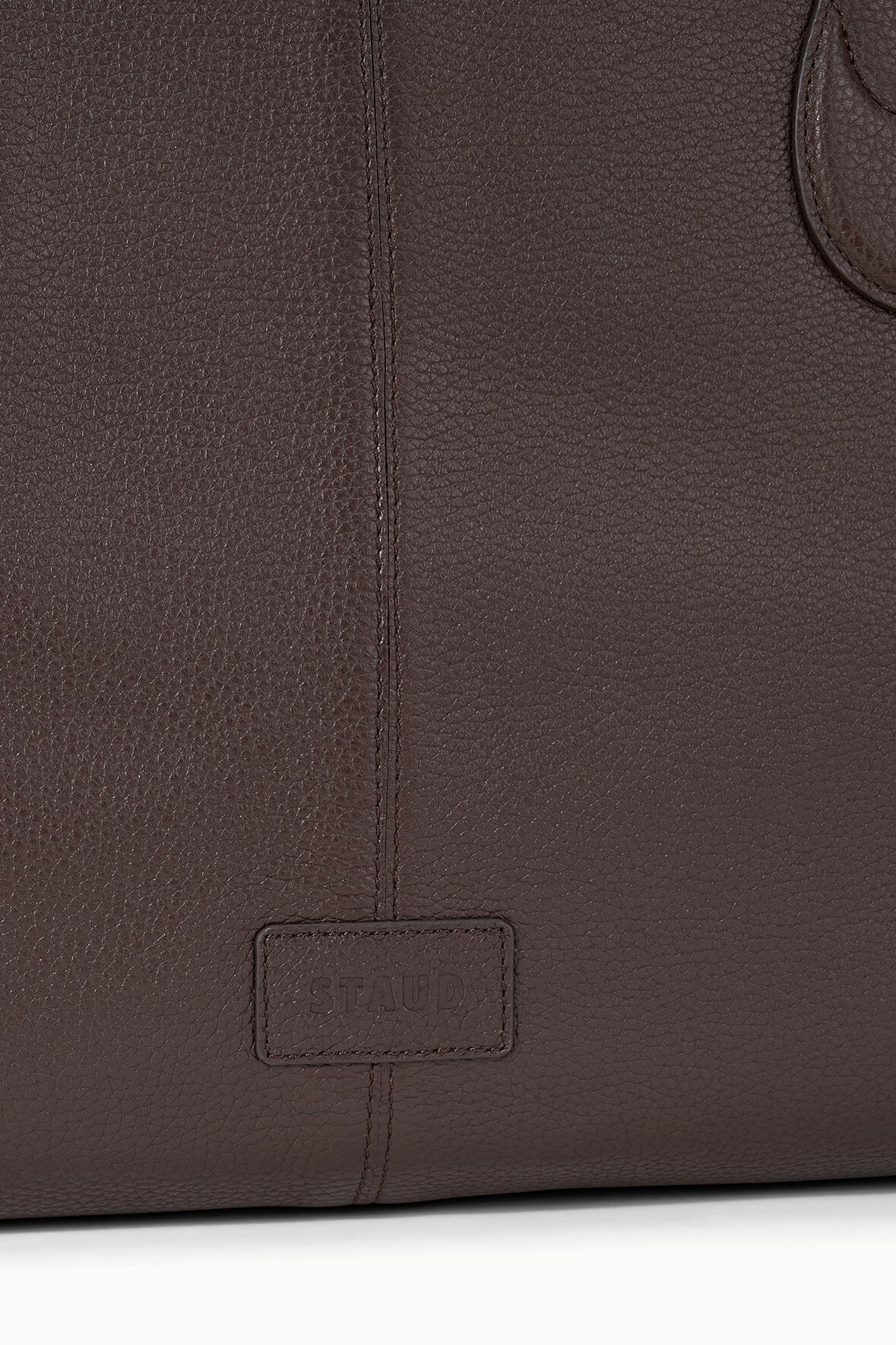 Espresso-brown tote bag back panel with stitched logo patch