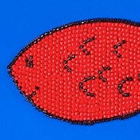 Close-up of red fish embroidery on blue one-piece swimsuit