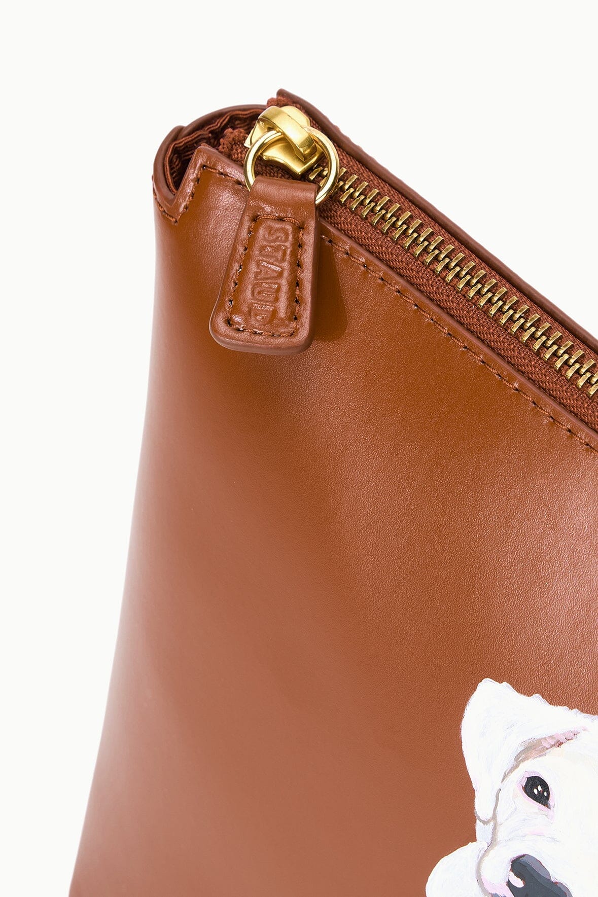 Tan zipper pouch with gold clasp and brown leather-look zipper pull tab.