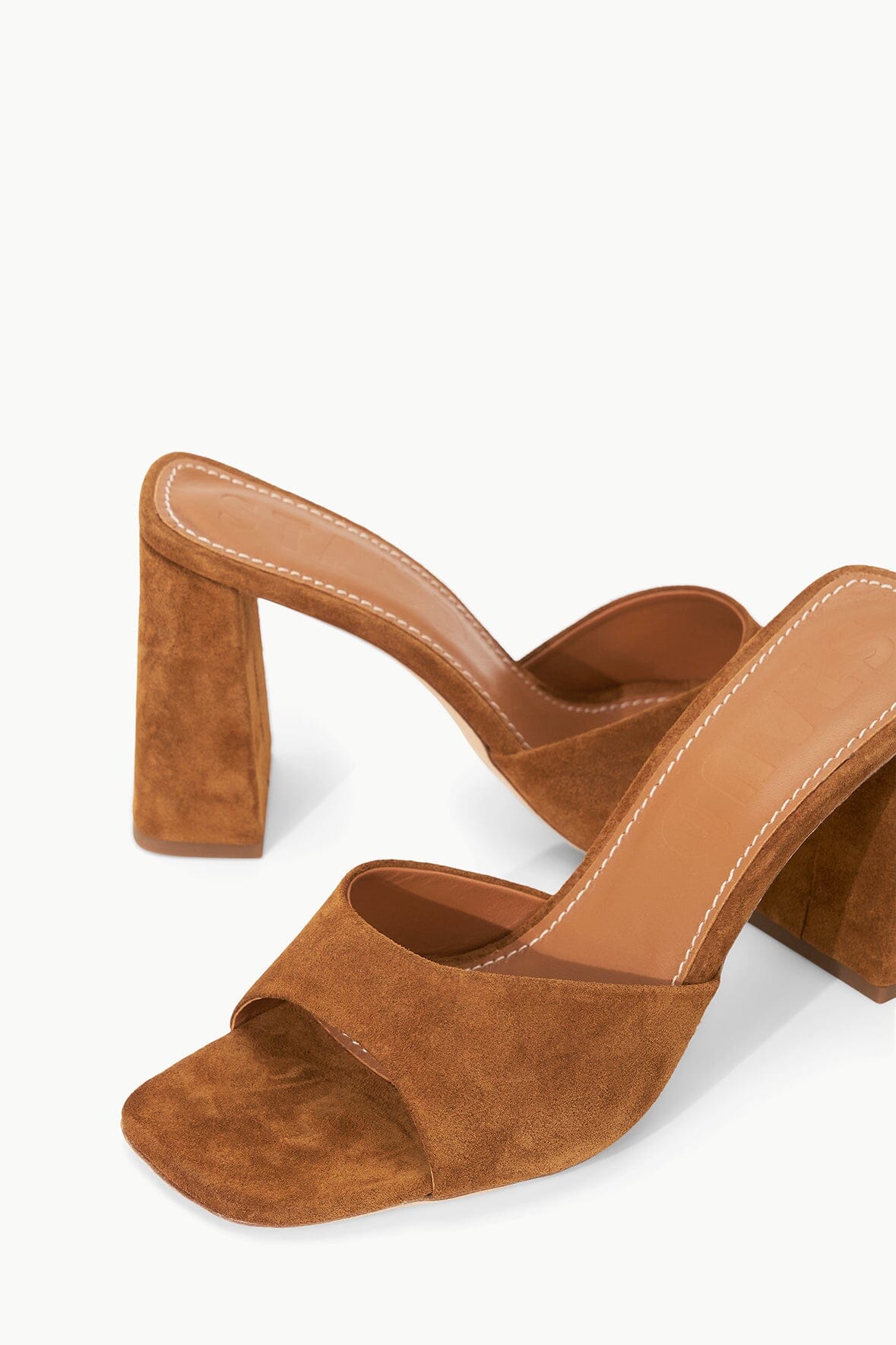 Tan suede mule sandal detail, open toe and stitched strap over foot