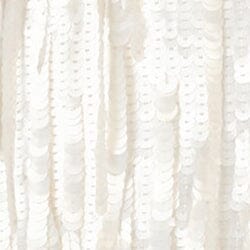 White sequin fabric close-up with raised bead texture
