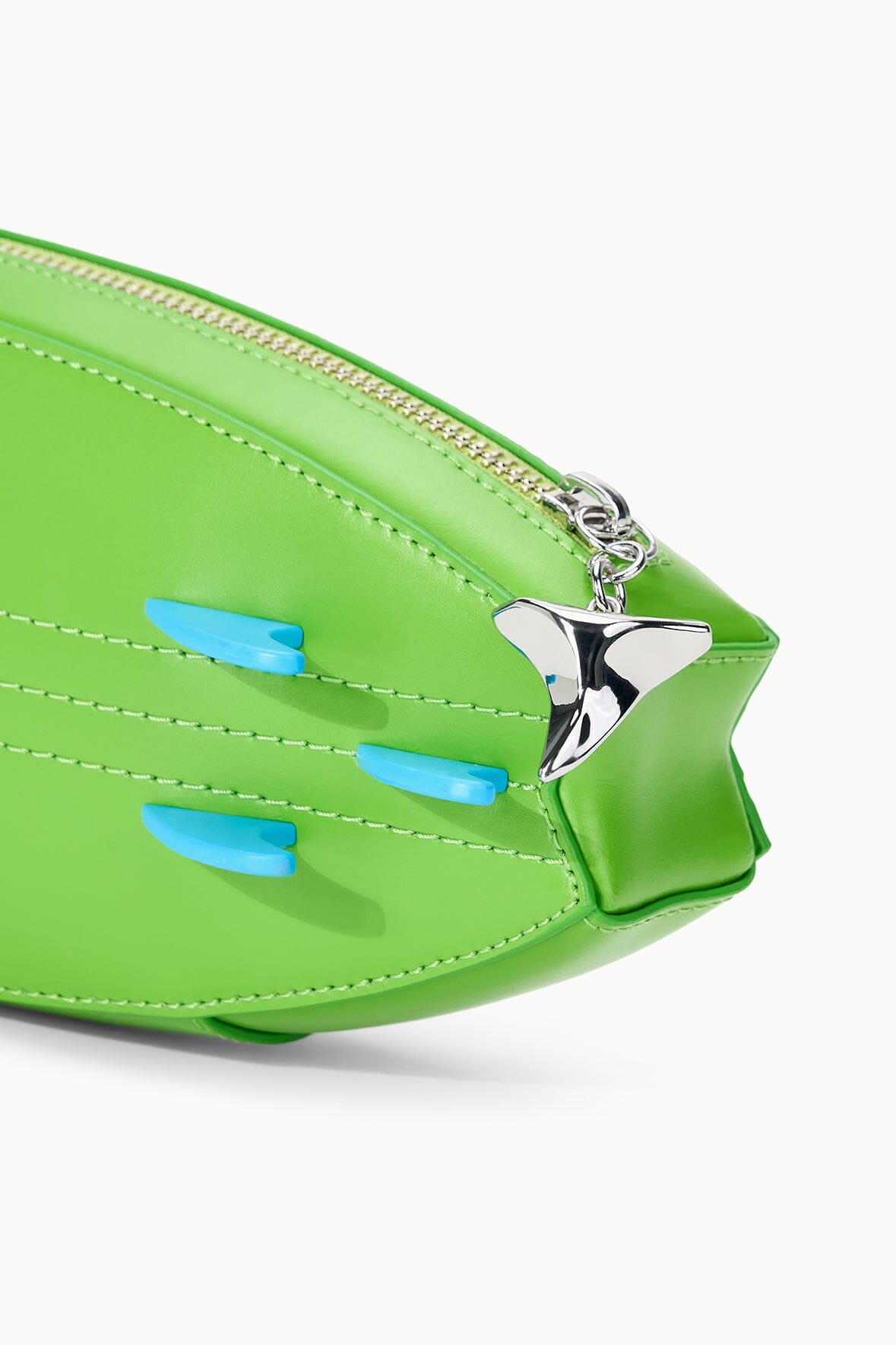 Green surfboard clutch with stitched panels, silver zipper pull, and blue graphic