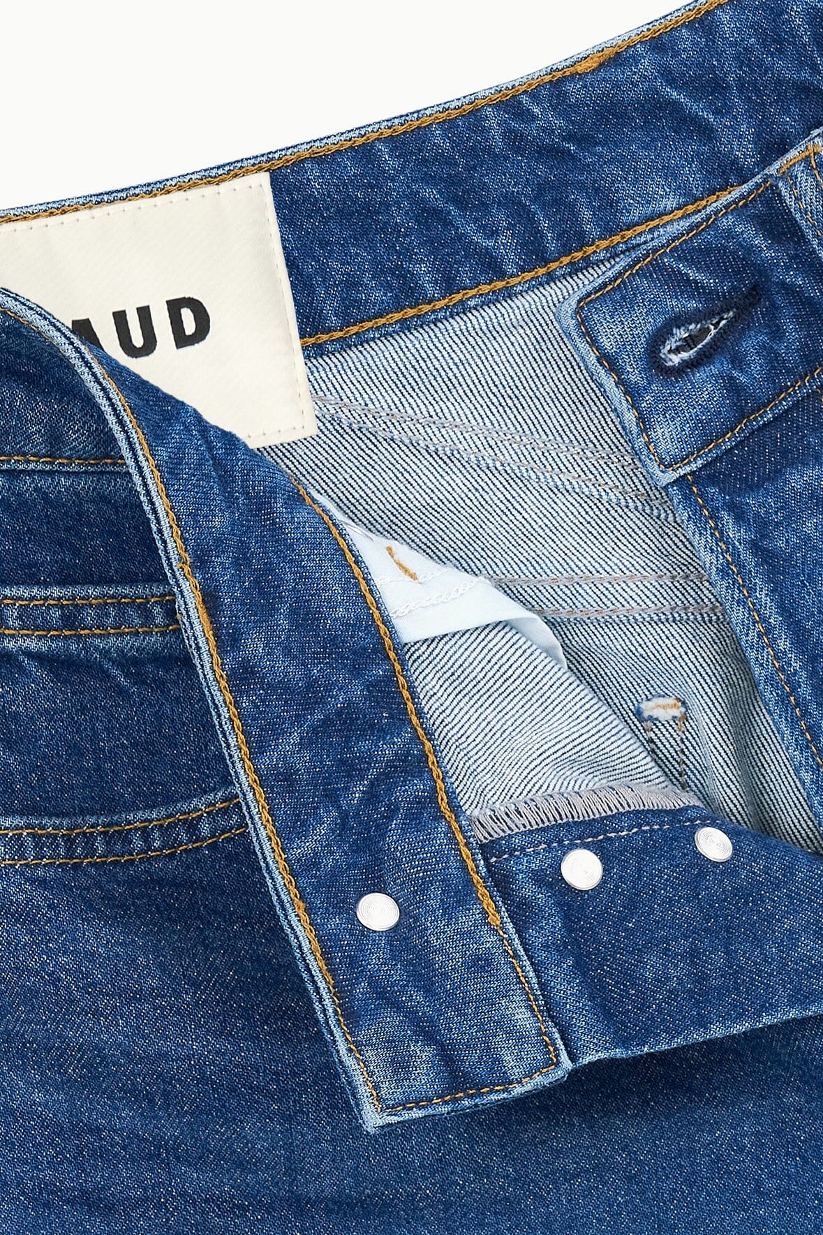 Vintage wash straight jeans close-up of inner label and contrast pocket lining.