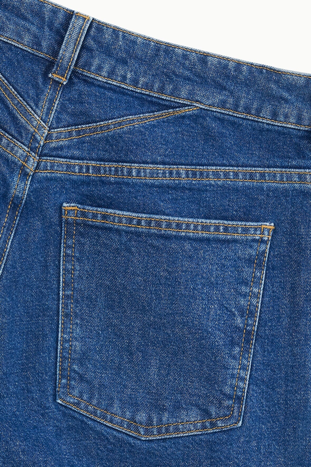 Stone blue denim jeans front pocket detail with contrast yellow stitching