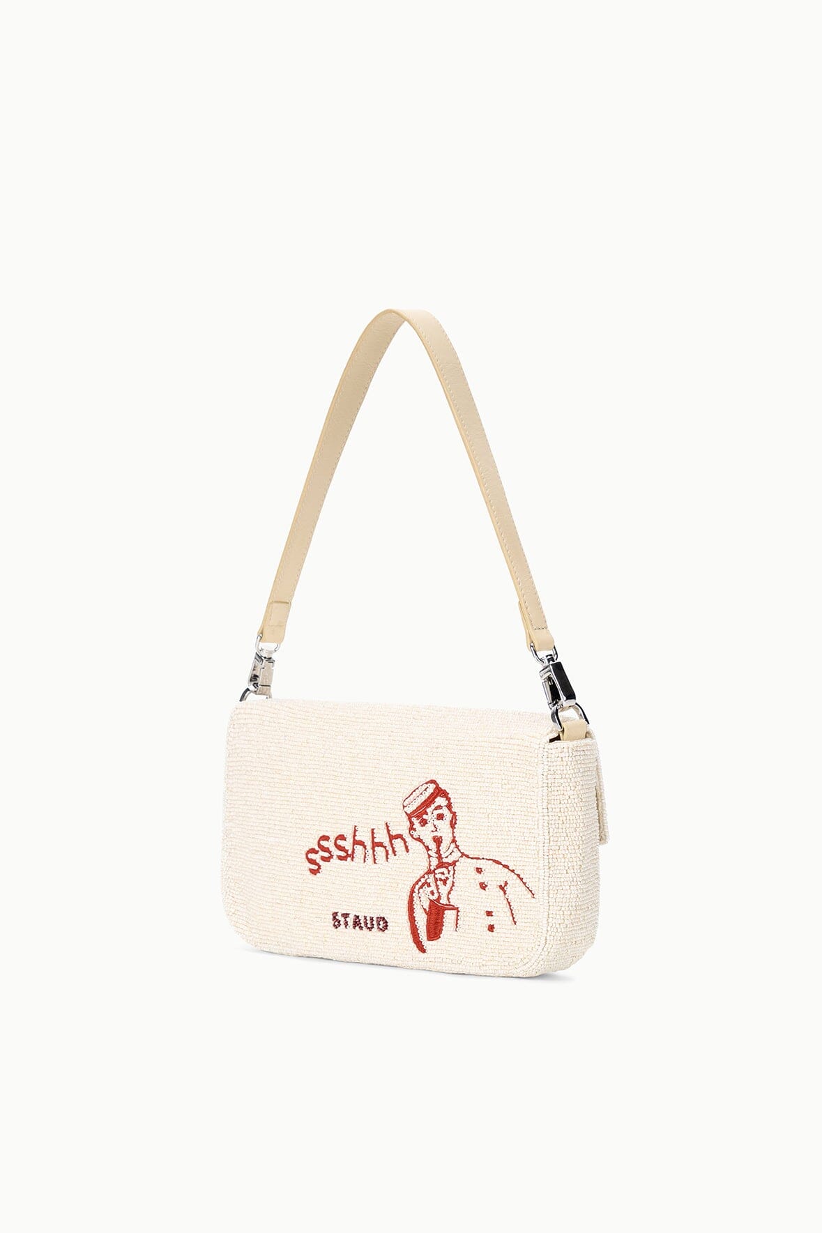 Cream tweed shoulder bag with red “ssshh” figure graphic and “STAY” text