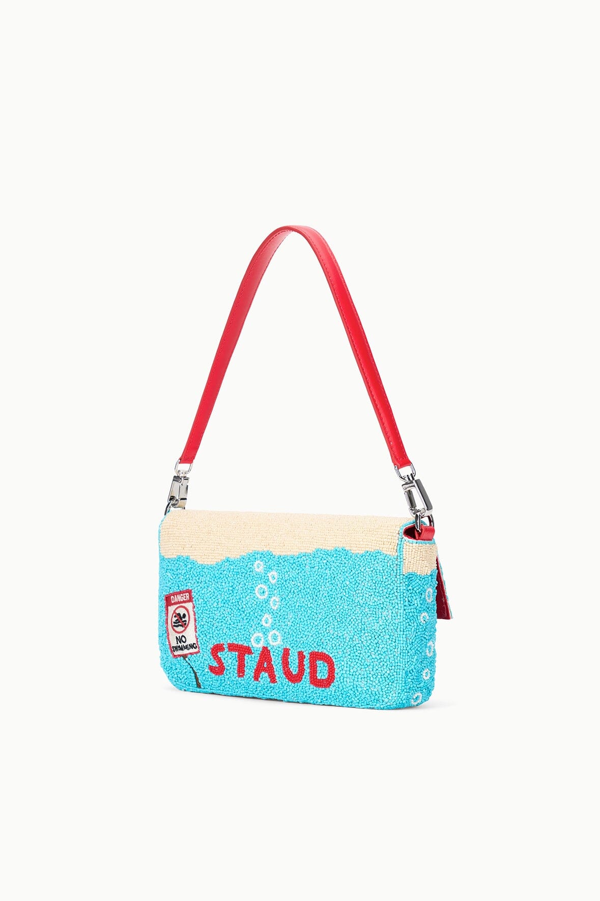 Turquoise sequin shoulder bag with red straps and “STAUD” graphic logo.